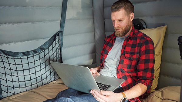 man on laptop in truck